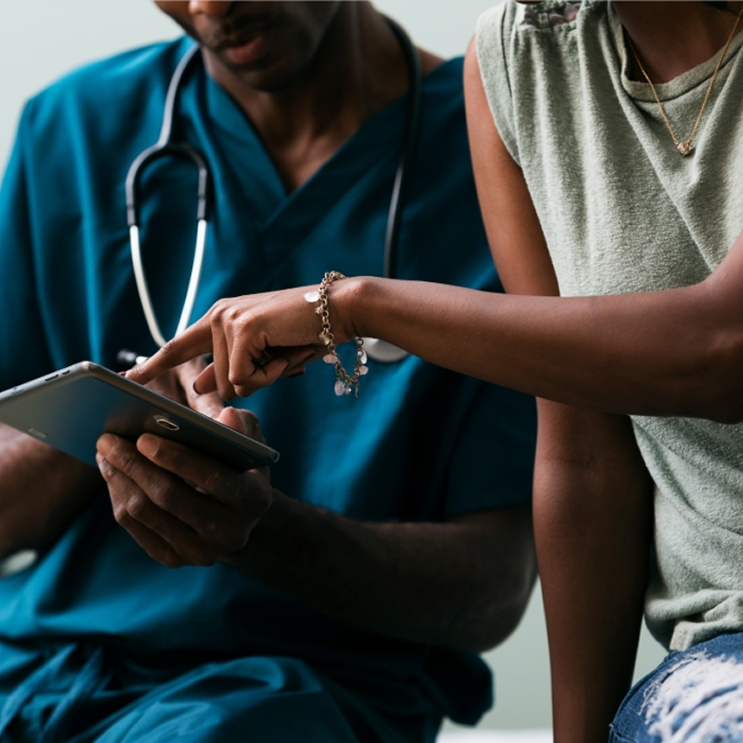 Patient and nurse reviewing medical information 1